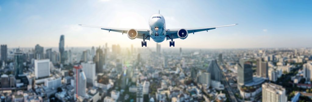 Descending airplane over a city