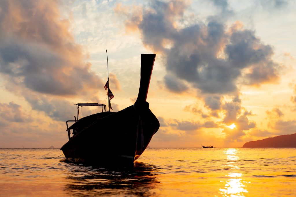 Long tail boat at sunset