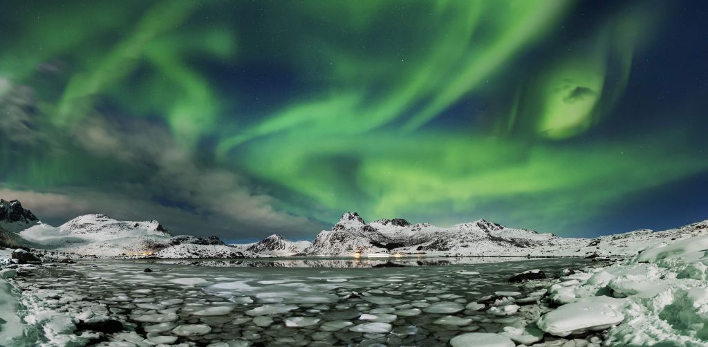 Northern lights above winter landscape