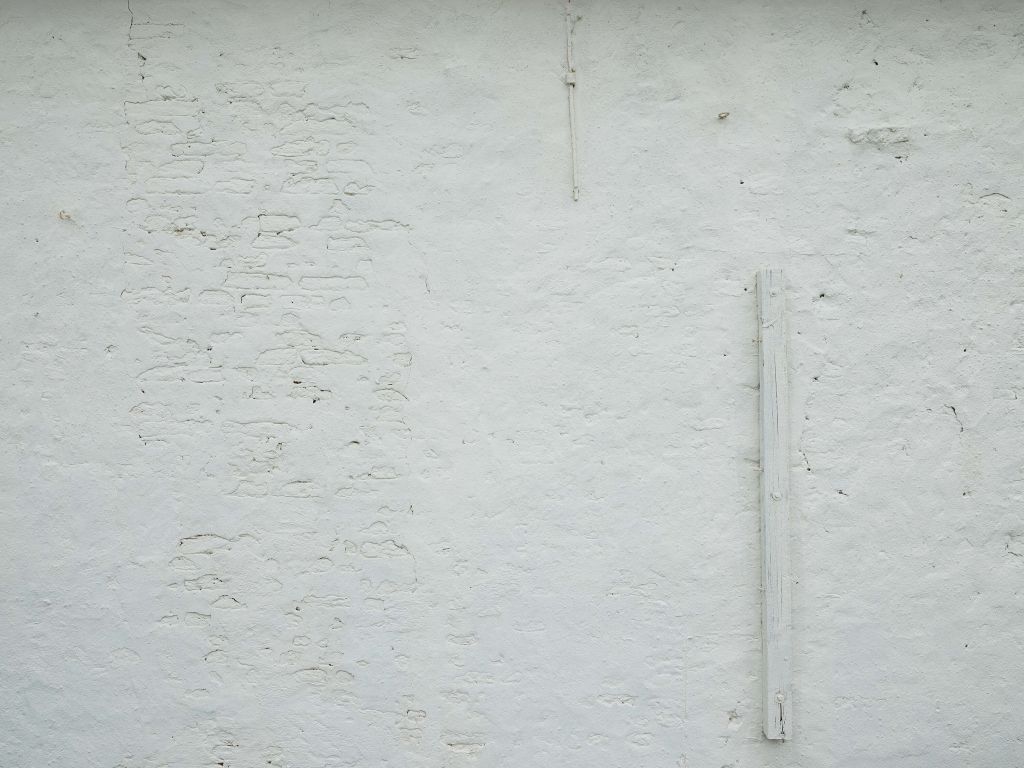 Wall with white stucco and beam
