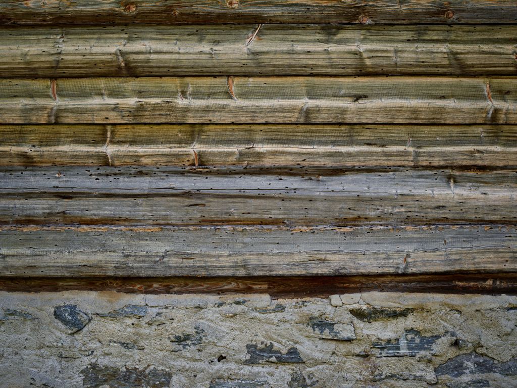 Weathered wood on stone wall