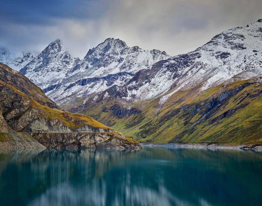 Mountain peaks with snow near mountain lake