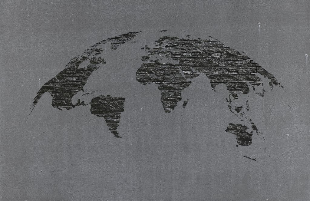 World map stones on grey concrete
