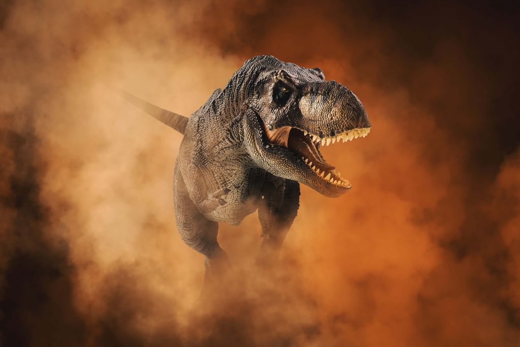 Tyrannosaurus walking through smoke