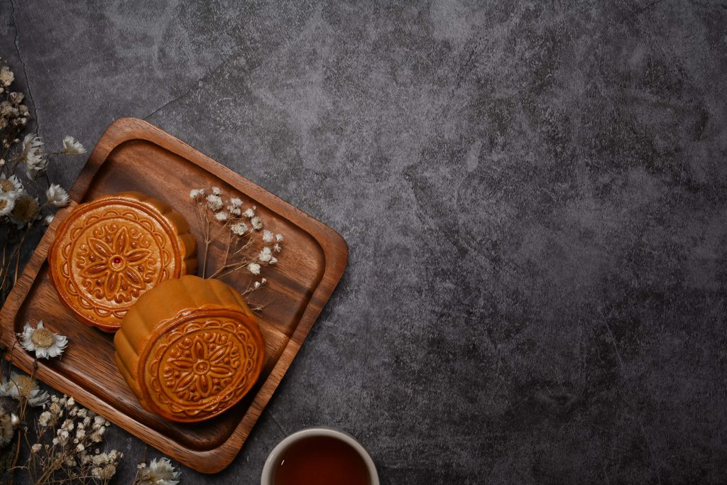 Moon cakes on a black countertop