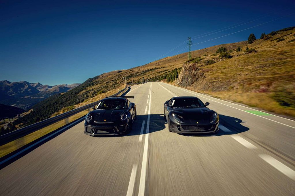 Black supercars in the mountains