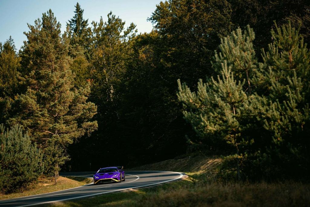 Purple Lamborghini Huracán in woodland landscape
