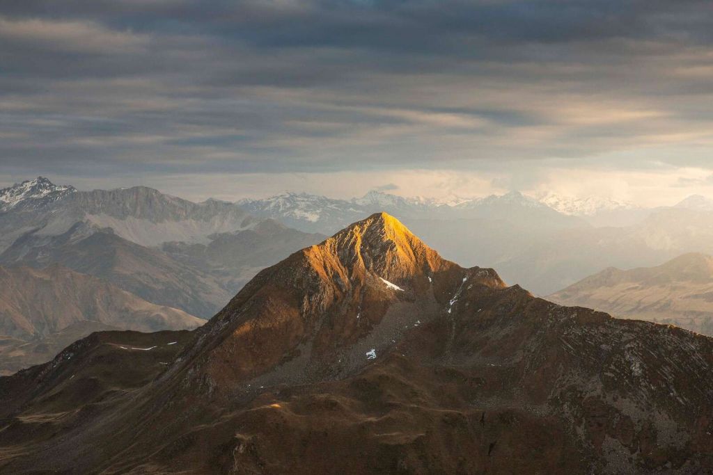 Golden sunlight on mountain top at sunrise