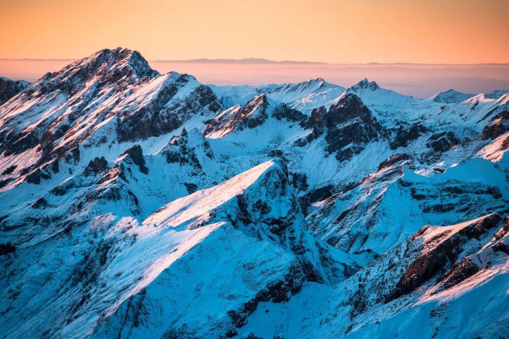 Sunrise over snow-covered mountain range