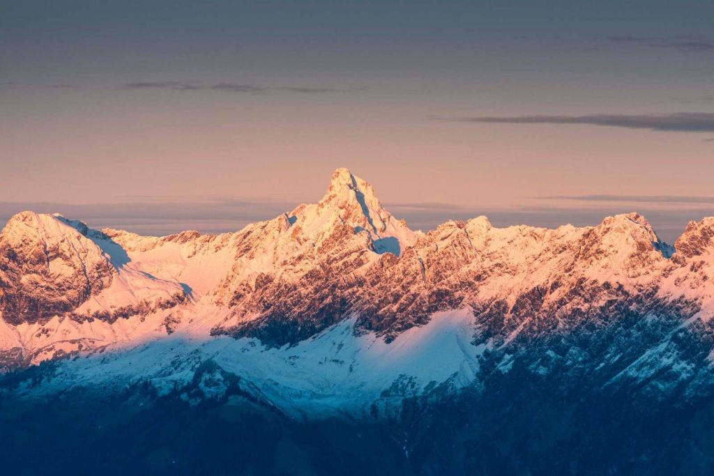 Evening light over snow-capped mountain peaks