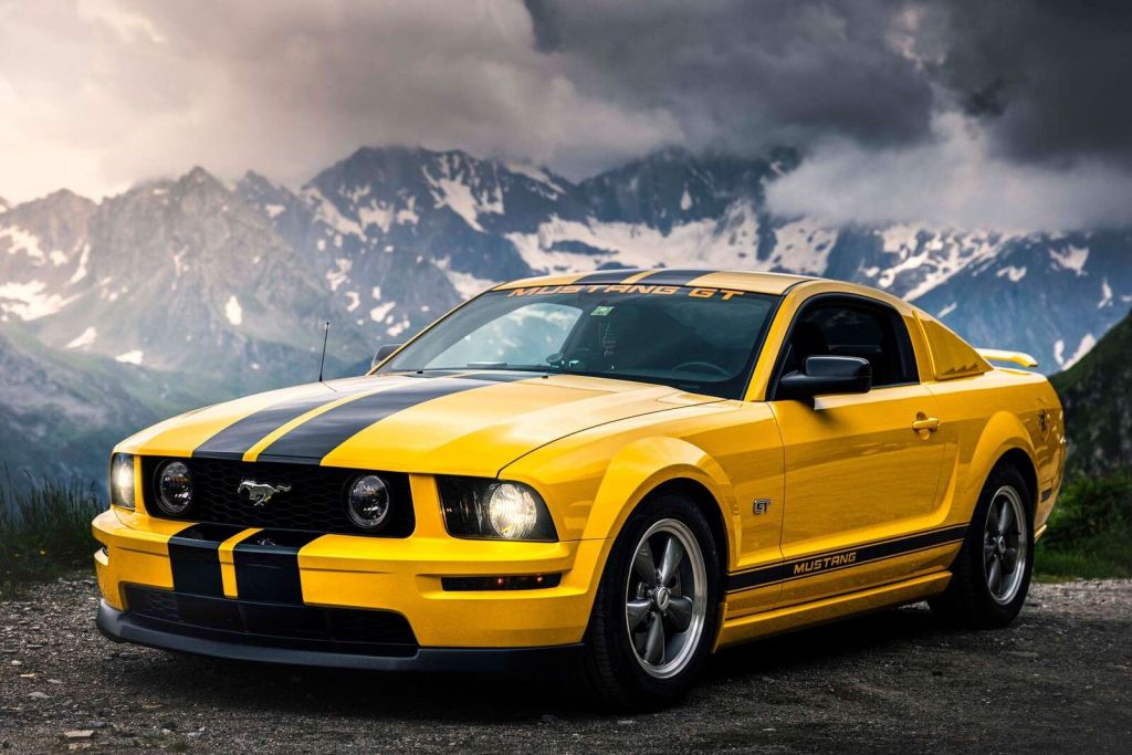 Yellow mustang in mountain landscape