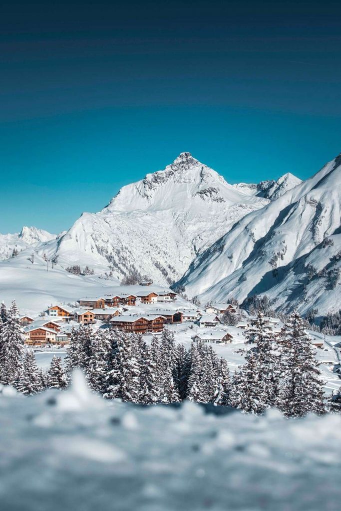 Mountain huts under wintry peaks