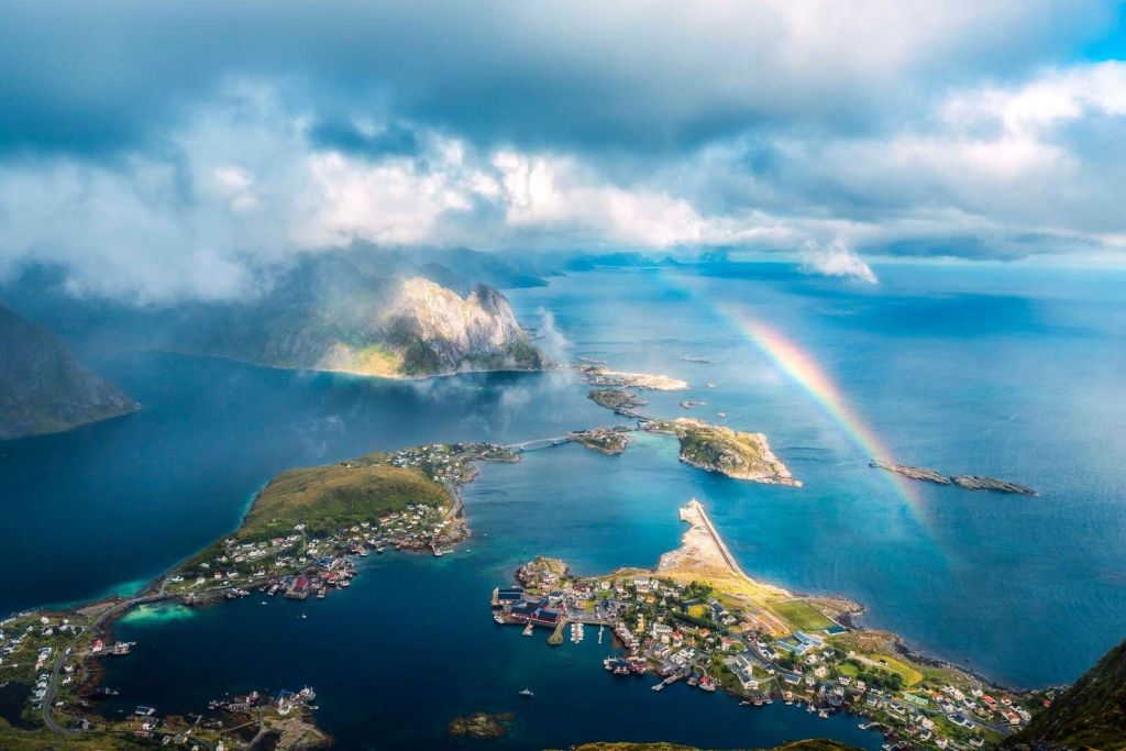 Rainbow light above fjord coast