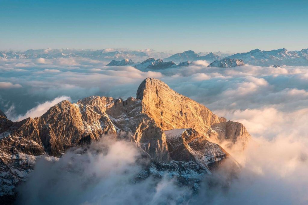 Snow-capped mountain peak in morning glow
