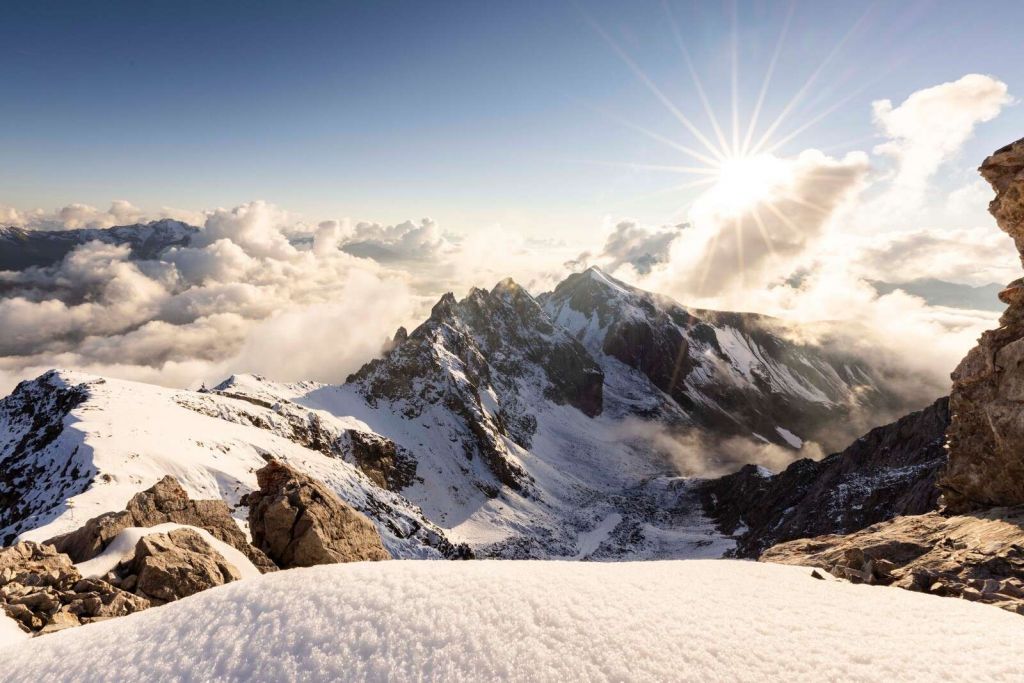 Sunlight Over Snowy Mountain Range