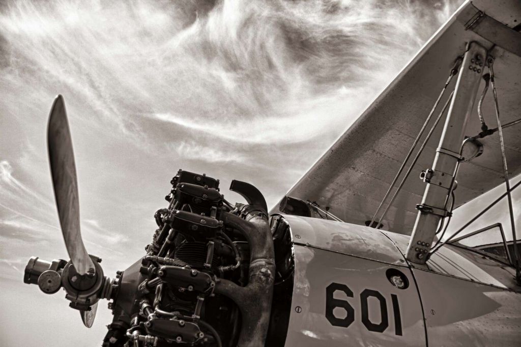 Vintage Propeller Flight Under Clouds
