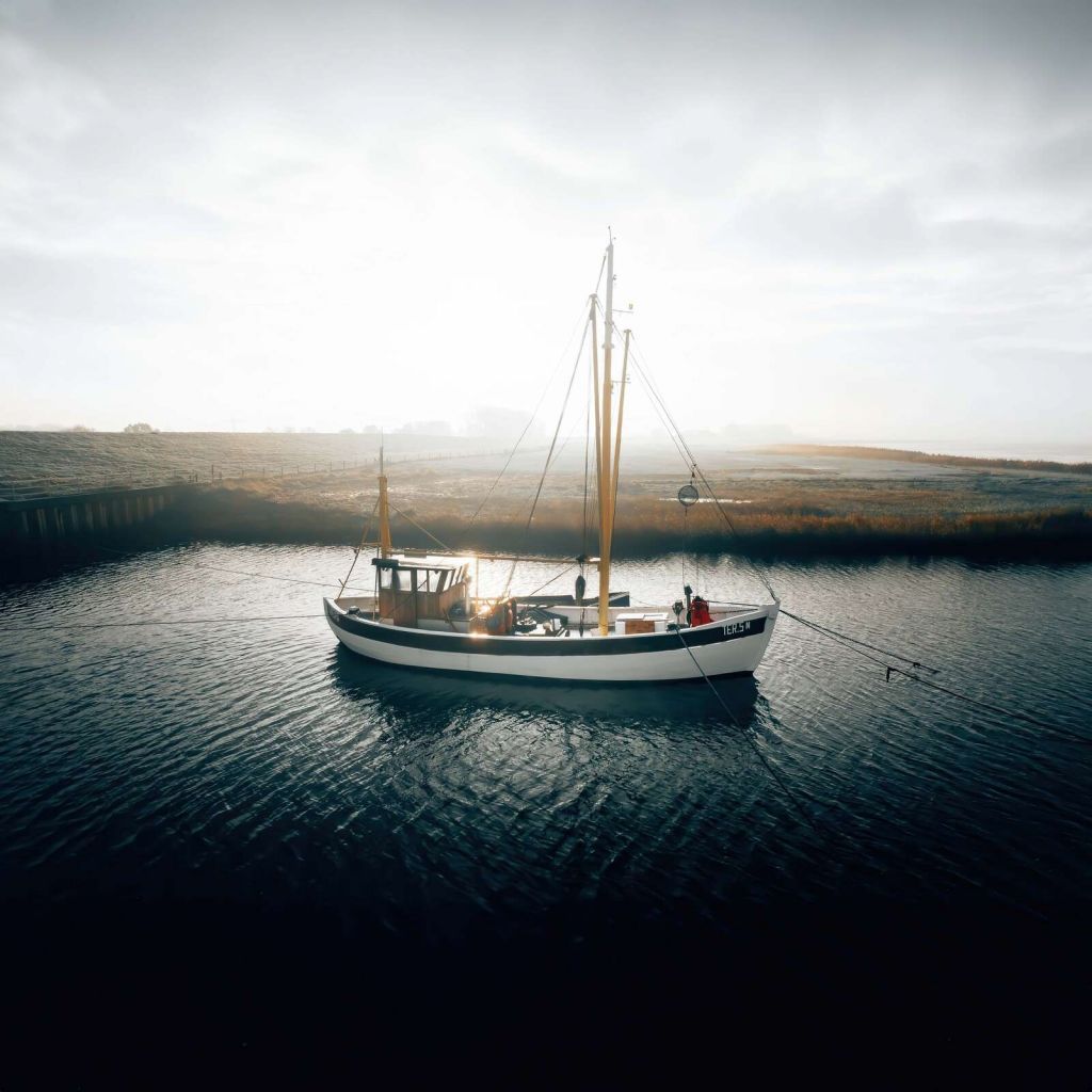 Fishing boat in morning light at the quay