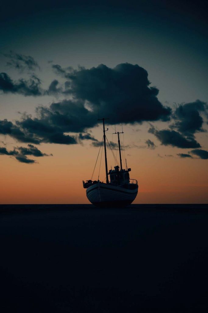 Stranded fishing boat at sunset