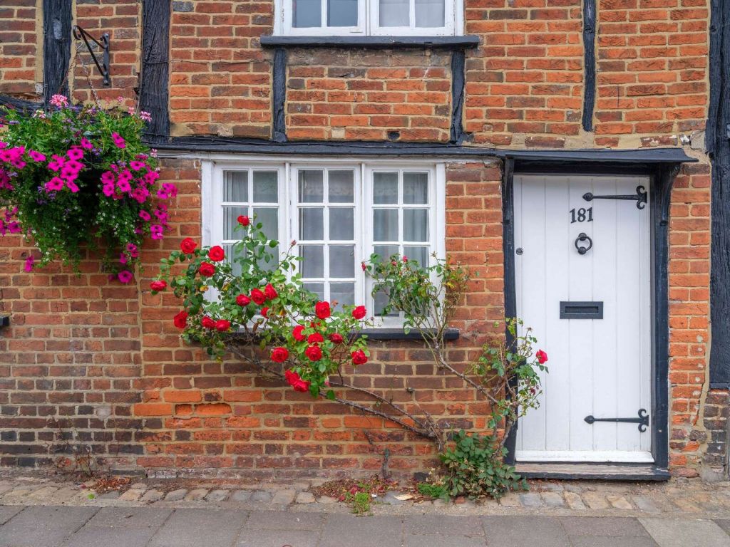 Brick cottage with red roses