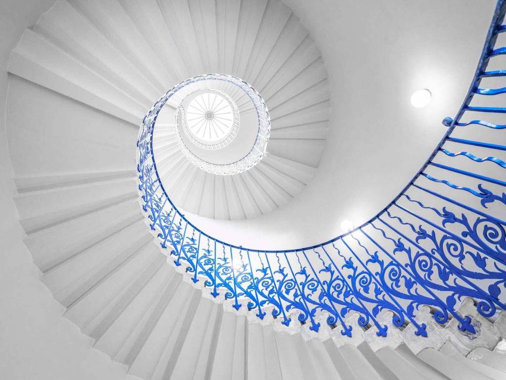 White spiral staircase with blue railing