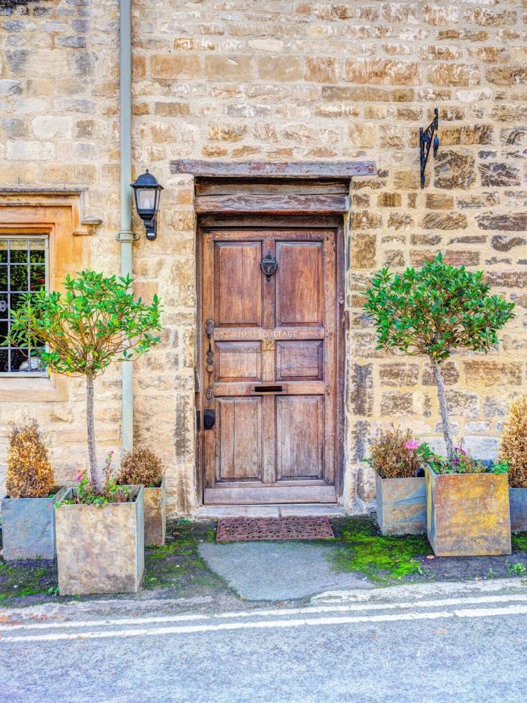 Rustic wooden door in stone wall