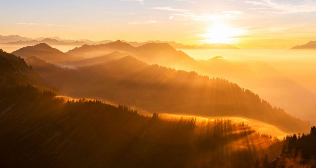 Sun rays over mountainous landscape