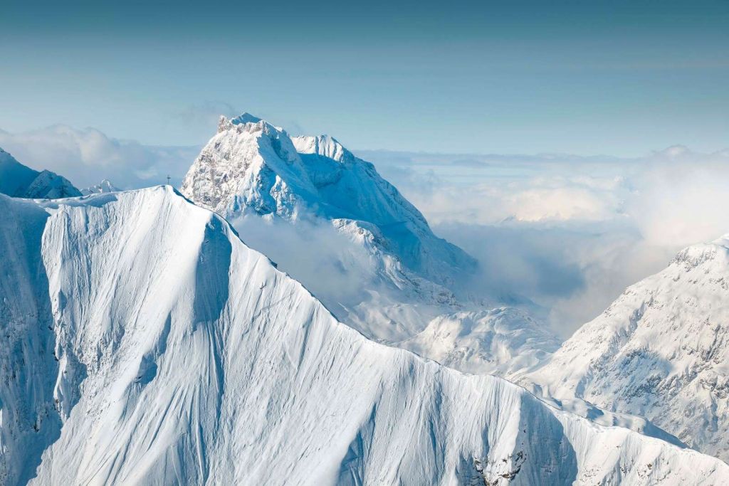 Snow-covered mountains above the cloud cover