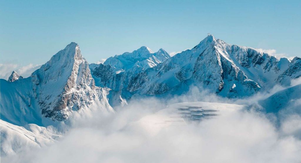 Snow-covered mountain peaks in mist
