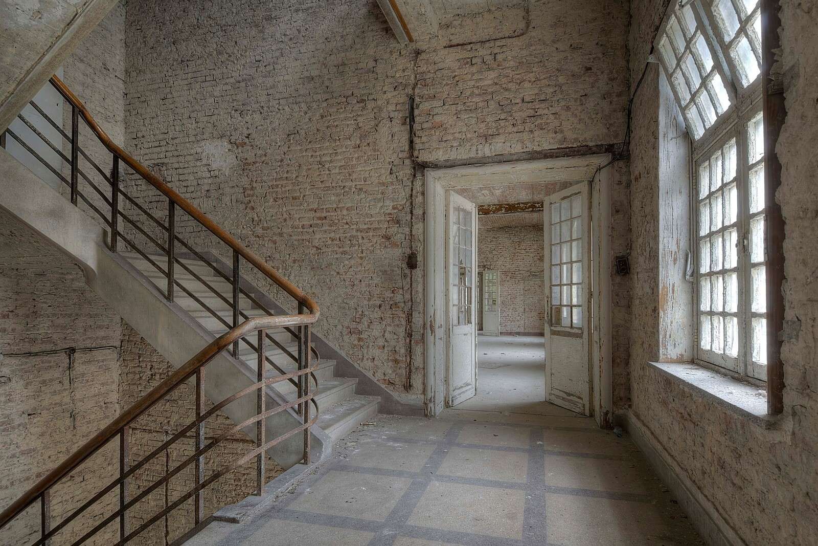 Empty corridor with brick walls