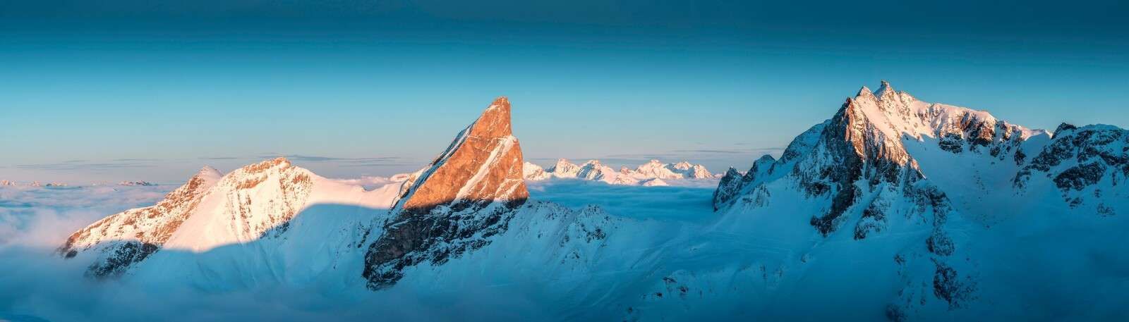 Morning light on snow-covered mountain ridge