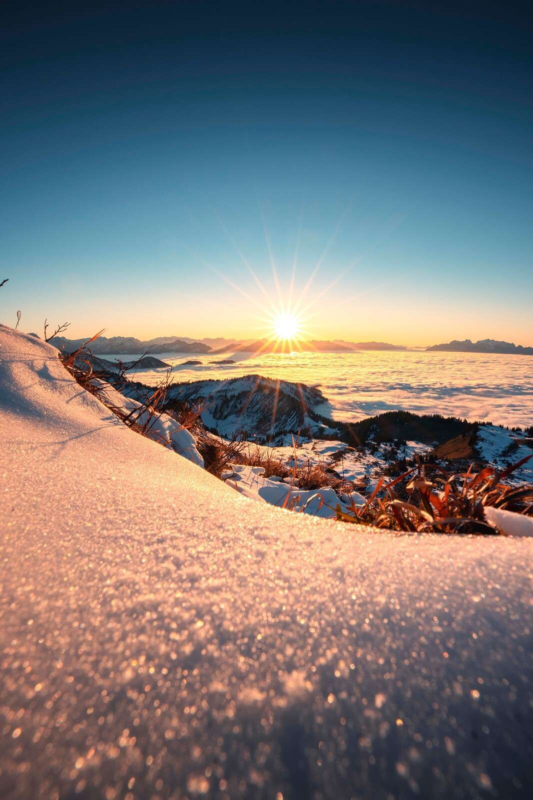 Sunlight over snowy alpine slope