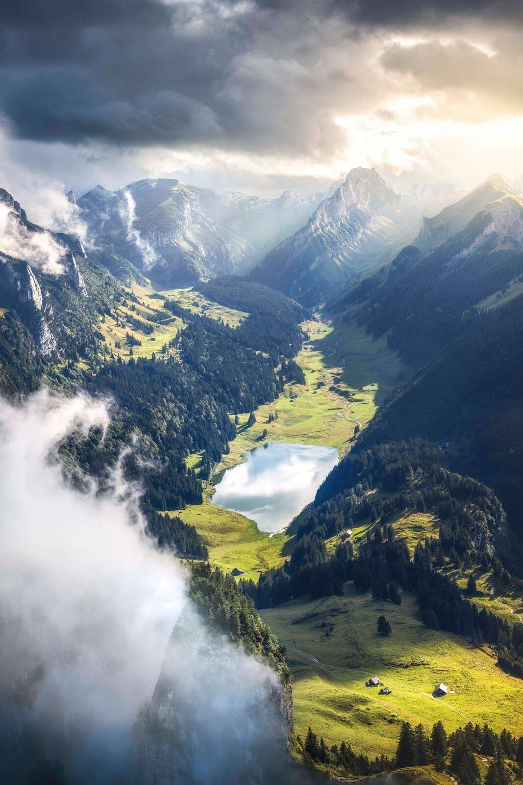Sunlight over mountain lake in valley