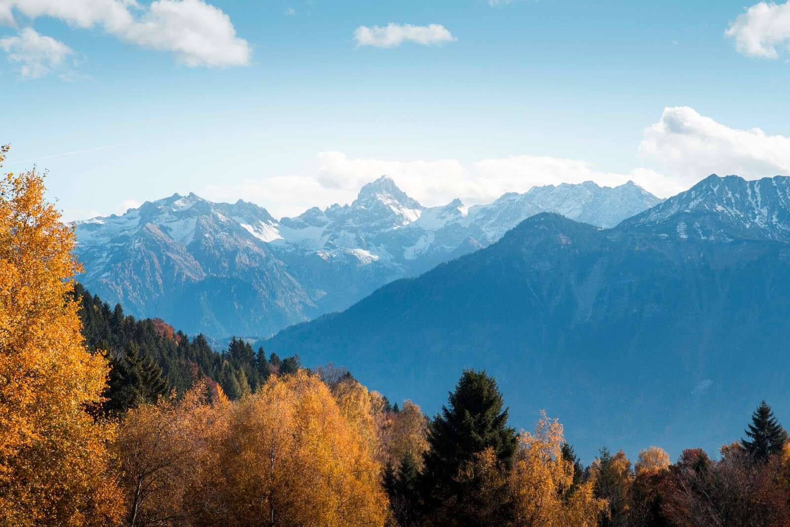 Autumn colors for snow-capped mountain peaks