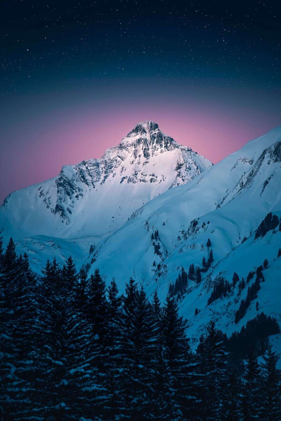 Snowy mountain top in starry night