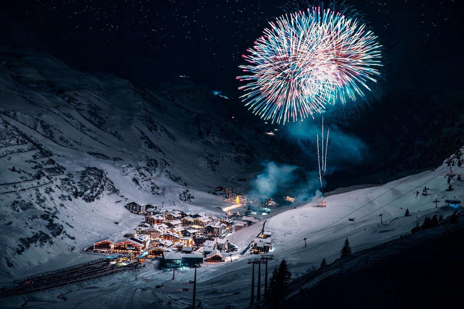 Fireworks above winter mountain village