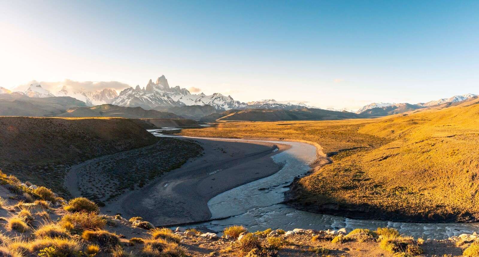 Mountain landscape with winding river in morning light
