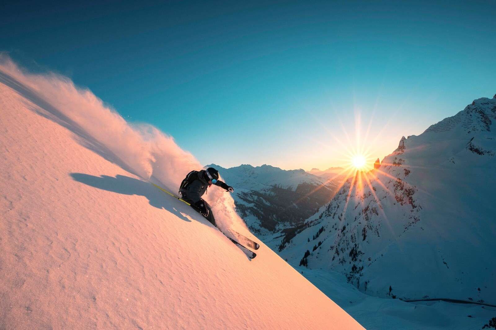 Snow descent at fiery sunset