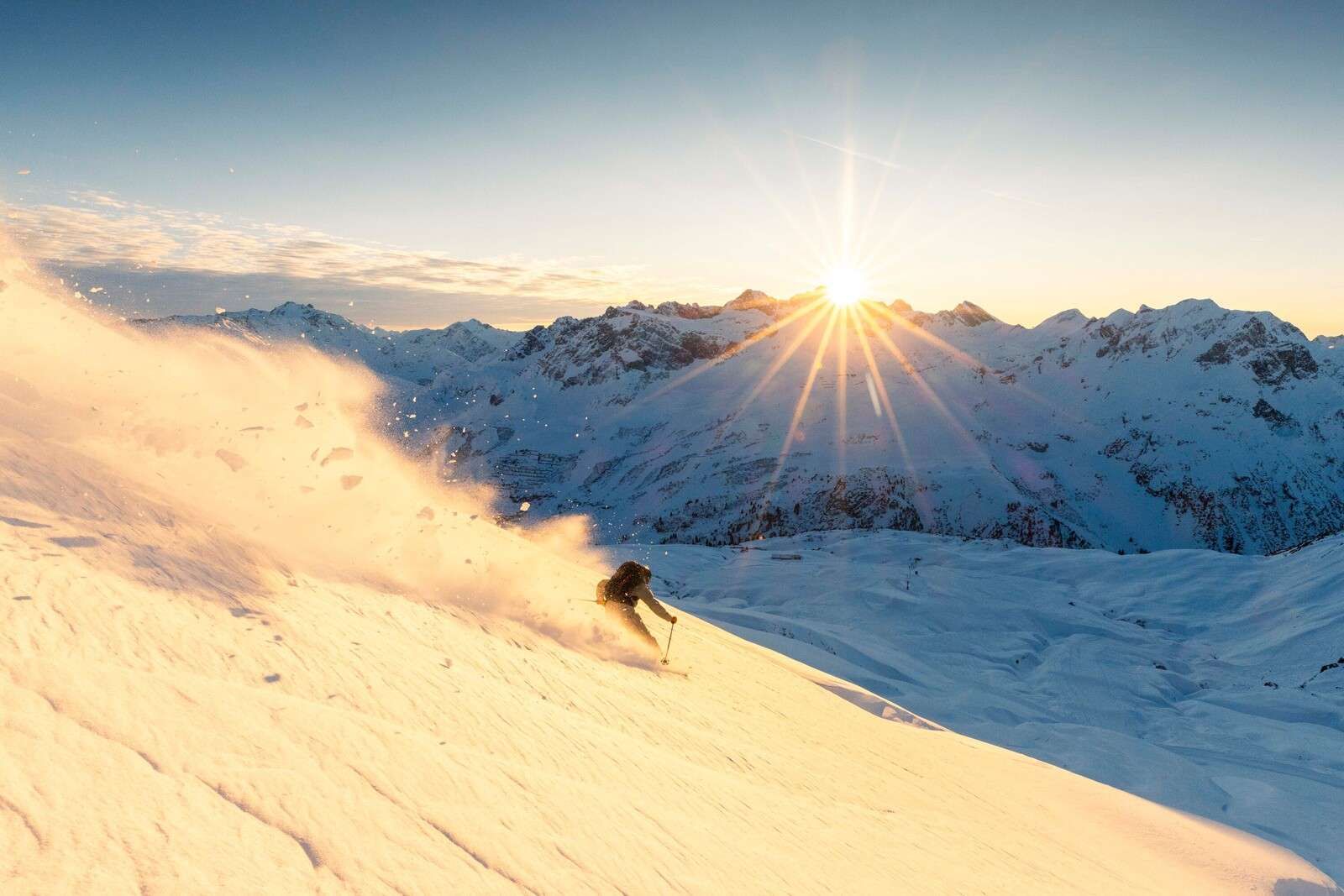 Skier in sun-drenched Alpine panorama