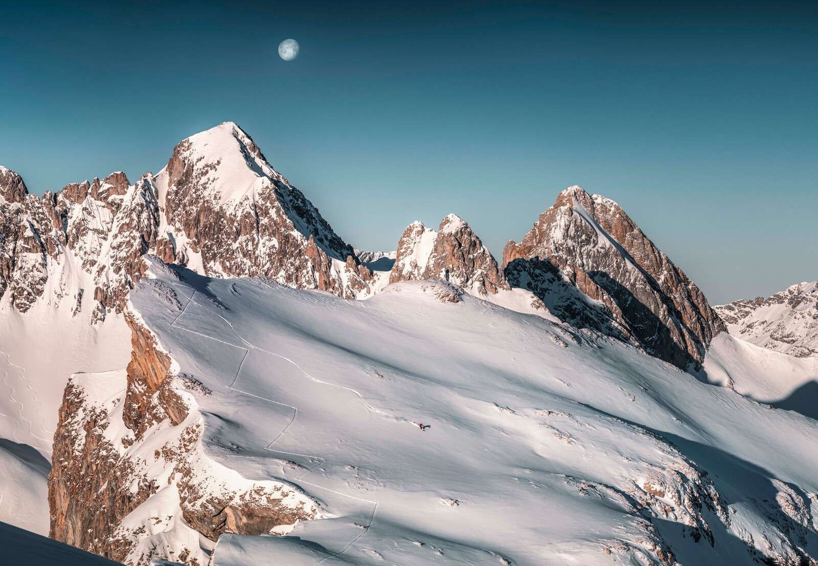 Moonlight over snow-covered alpine peaks