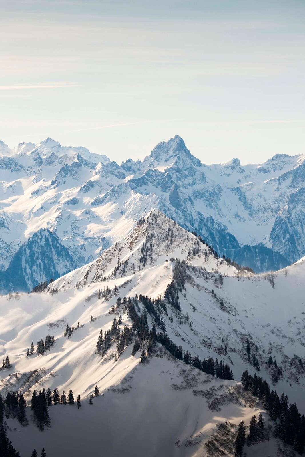 Winter comb with alpine peaks in sunlight
