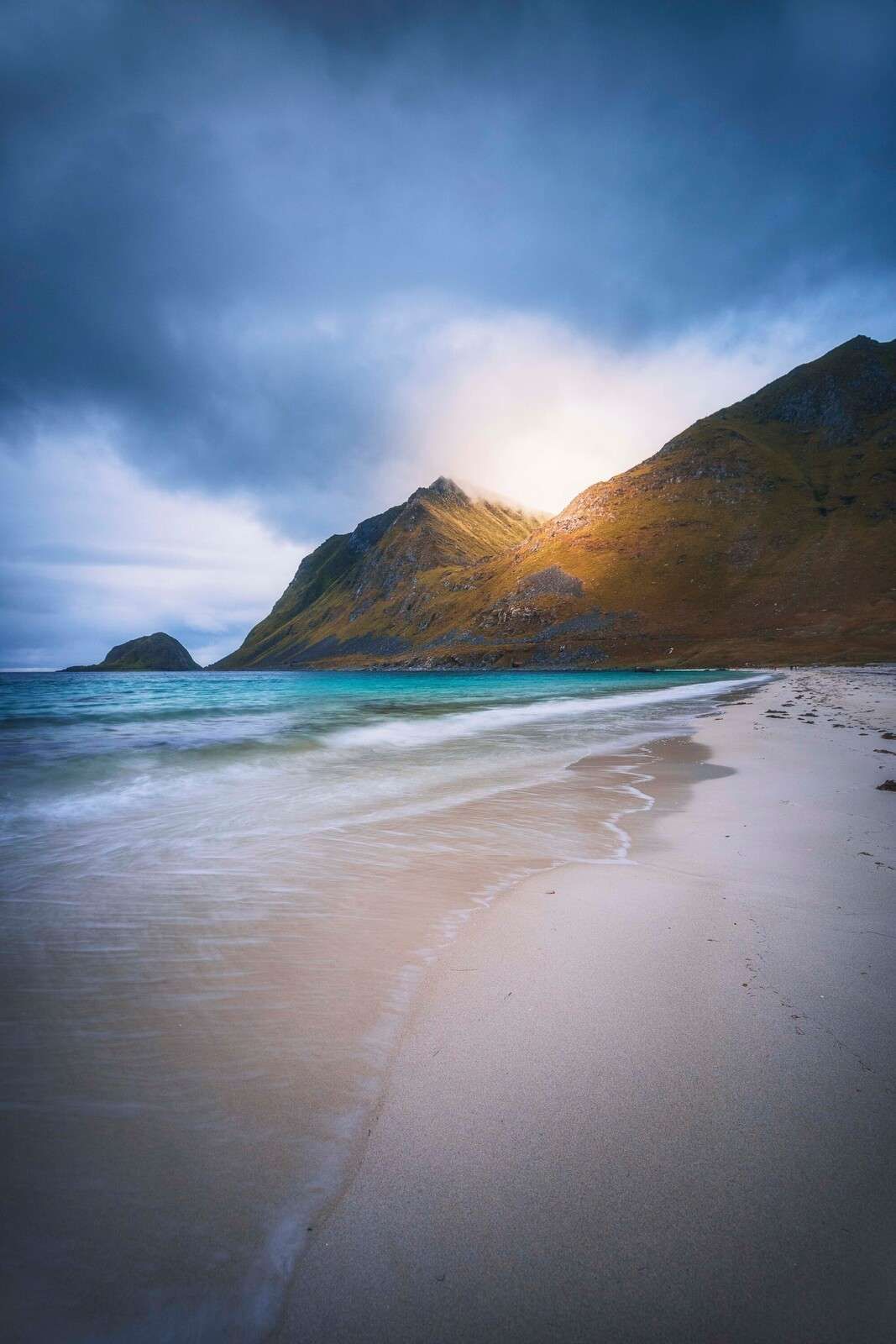 Sunlight on mountain and surf
