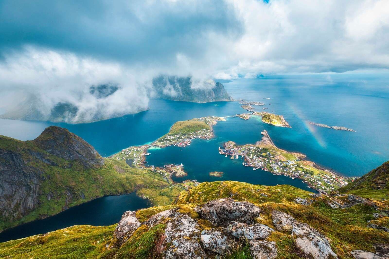 Rainbow above fjord village islands