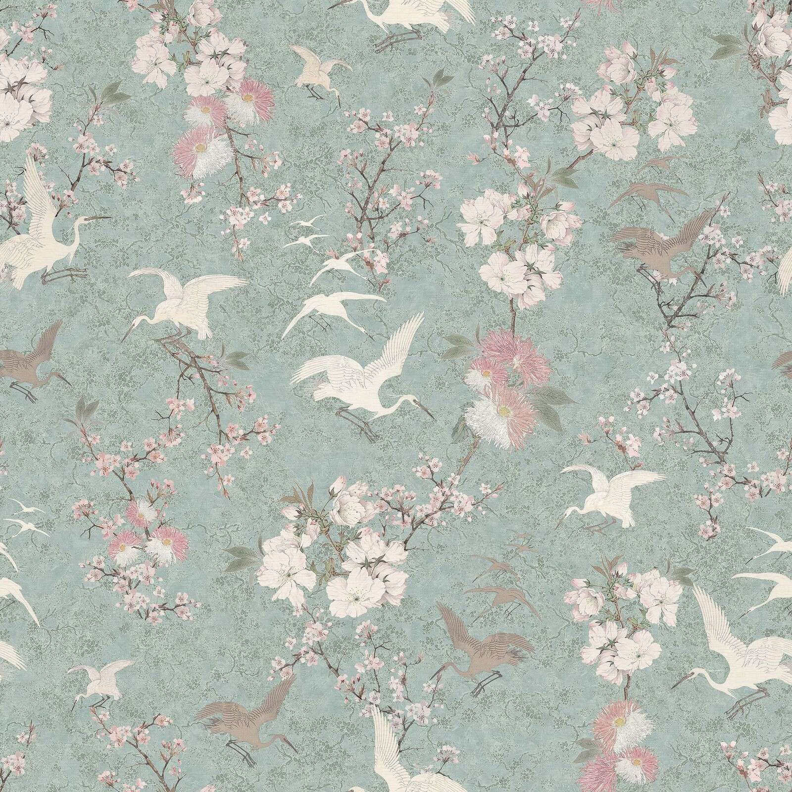 Cranes in a mint-green blossom garden