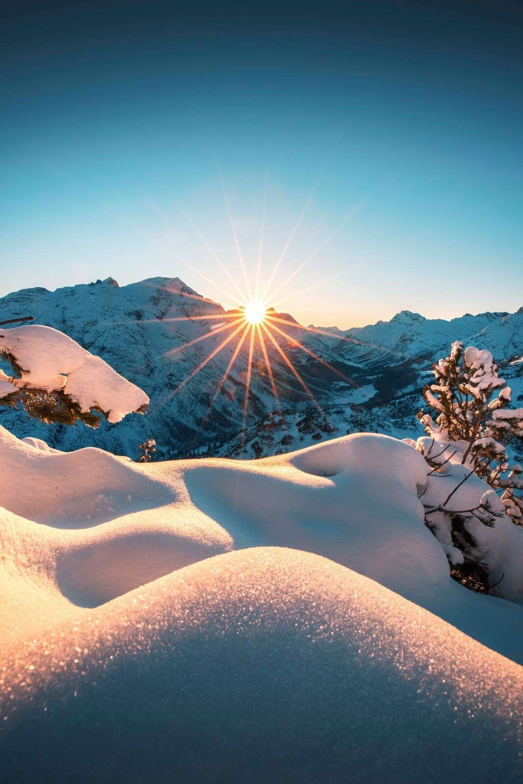 Morning sun over snow-covered valley