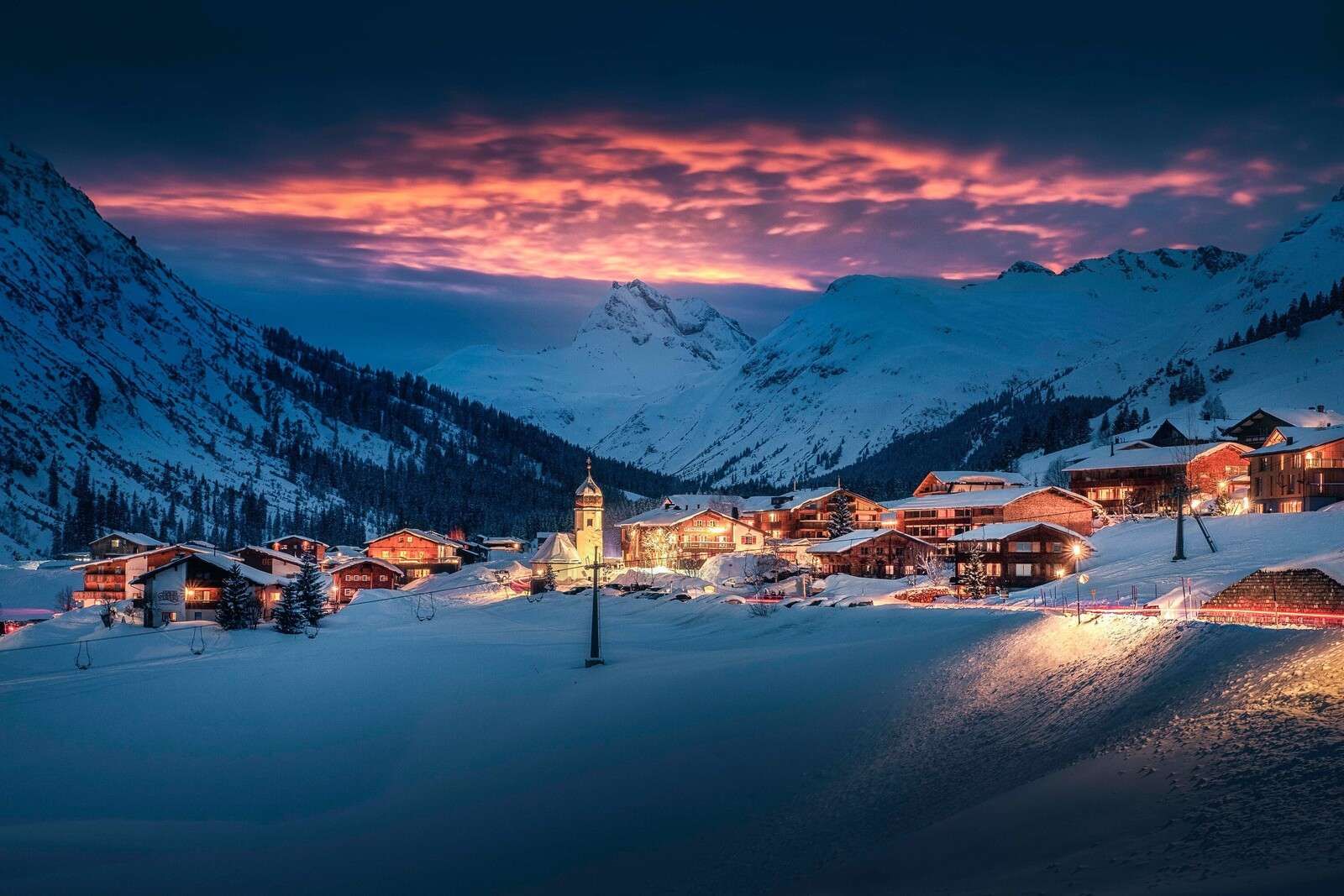 Evening light over mountain village in the snow