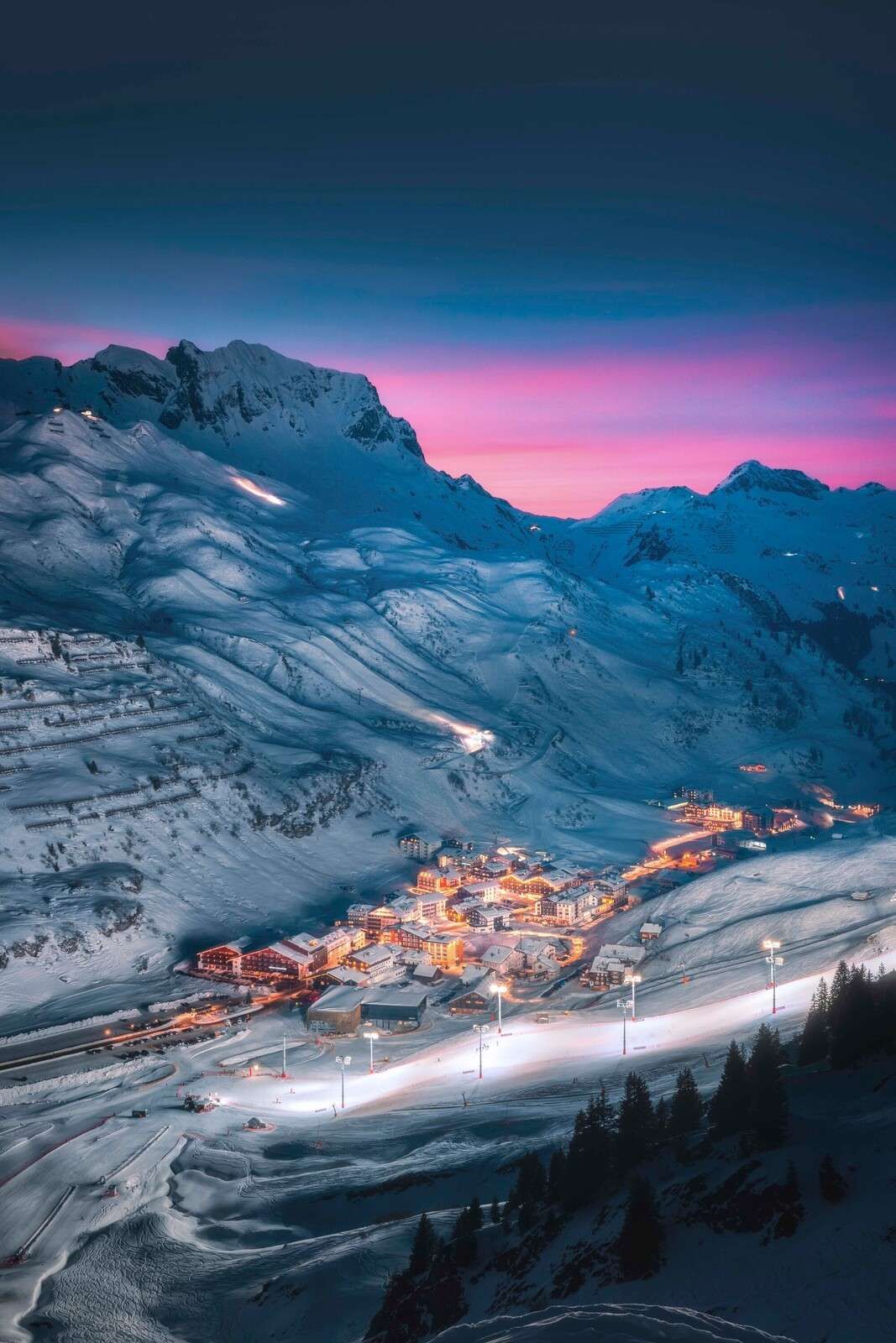 Snow village under purple evening sky