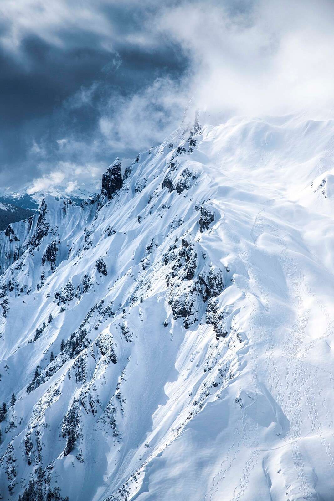 Snow ridges under stormy clouds