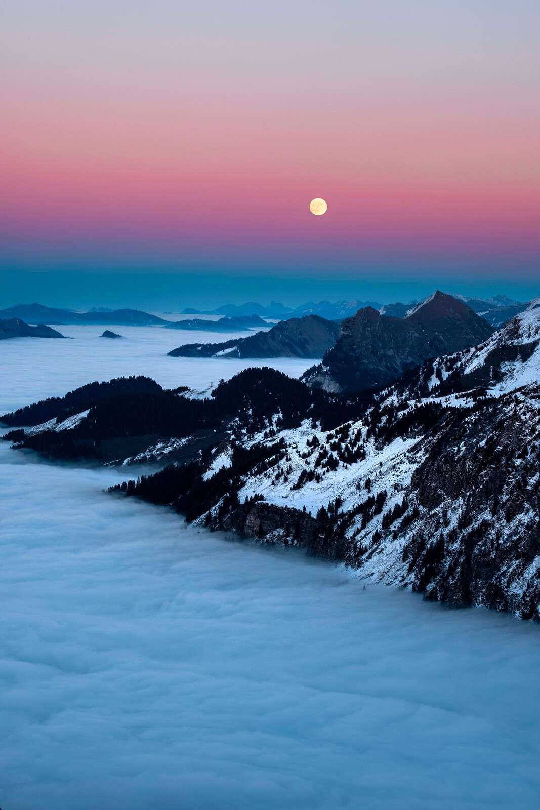 Moonlight above winter mountains