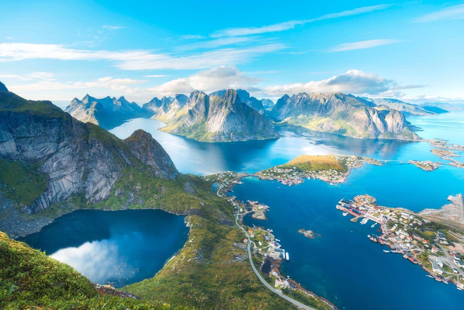 Mountain lake and fjord village in sunlight