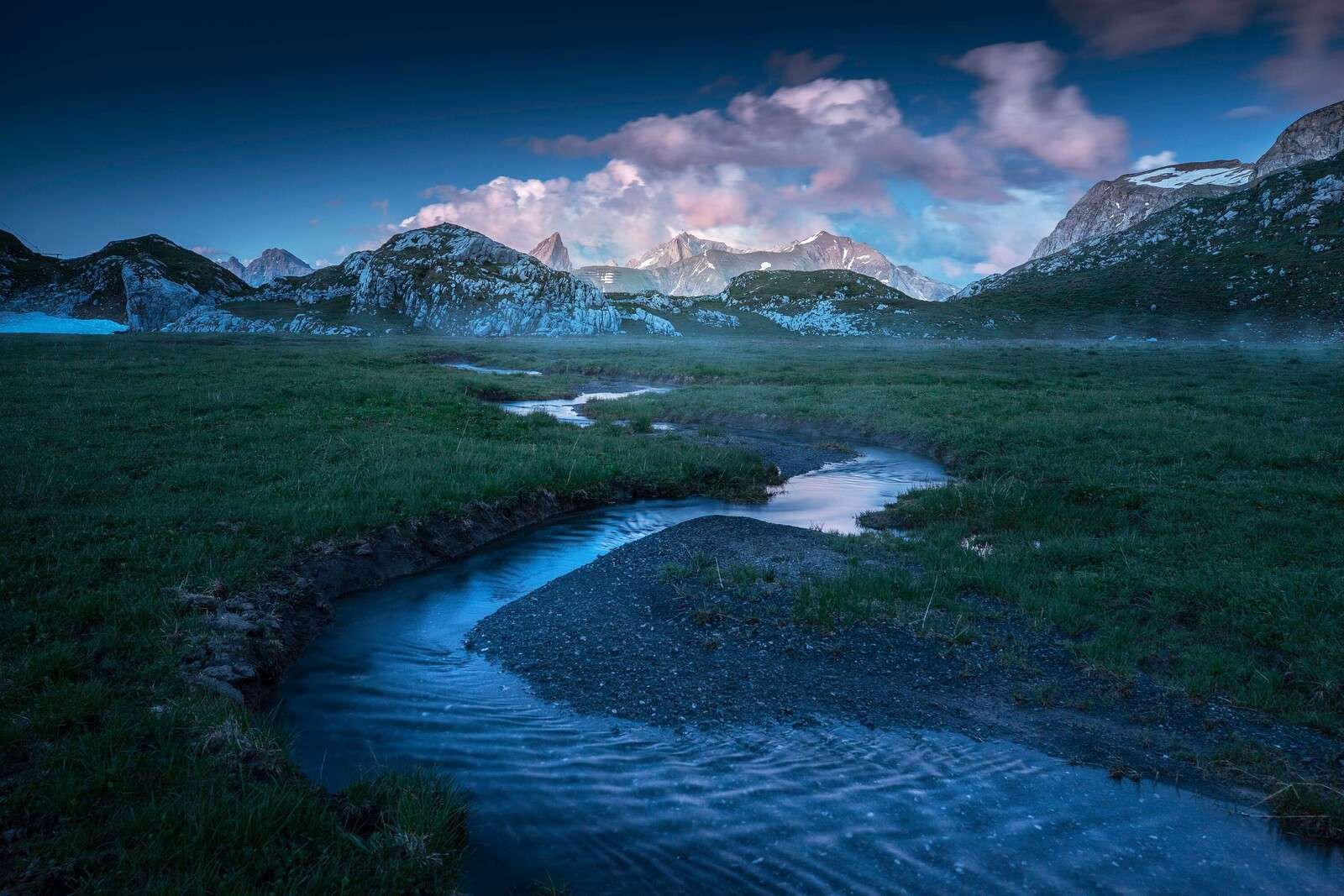 Evening light over mountain valley with stream